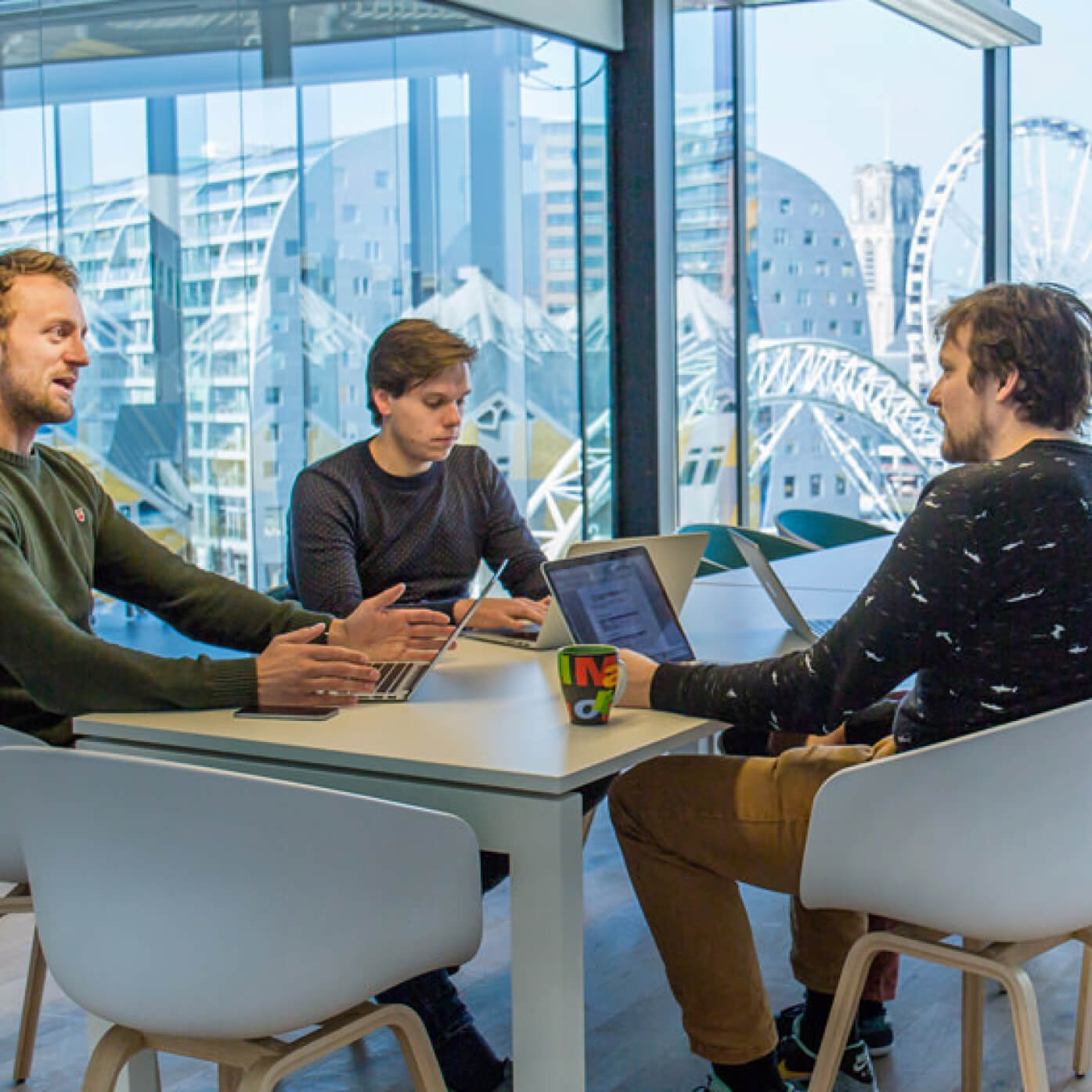 three men having a business meeting